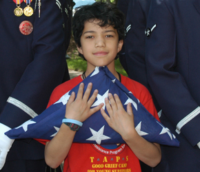 Little boy with folded flag